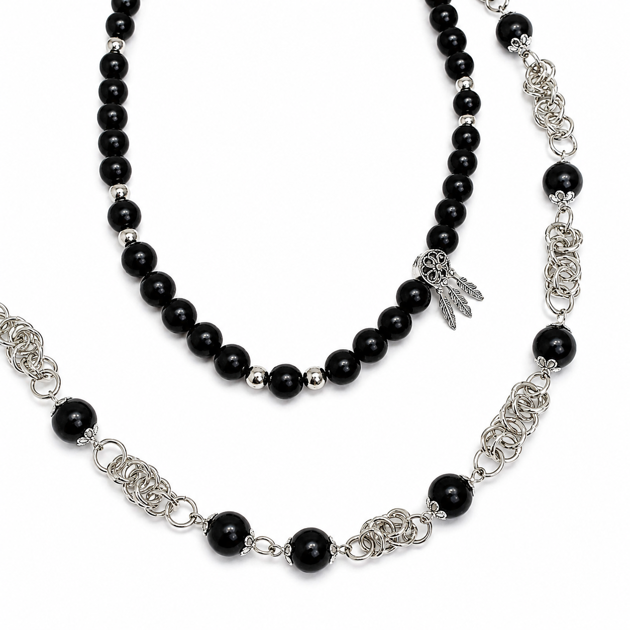 Necklace with black beads and silver chain on a white background