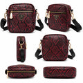 Red snake print bags with gold accents on a white background