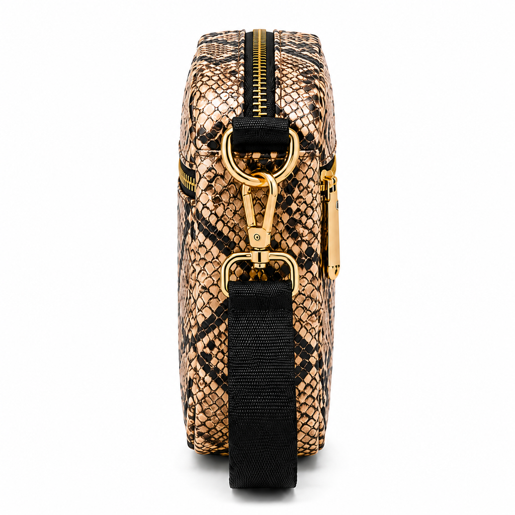 Snakeskin patterned bag with gold accents on a white background
