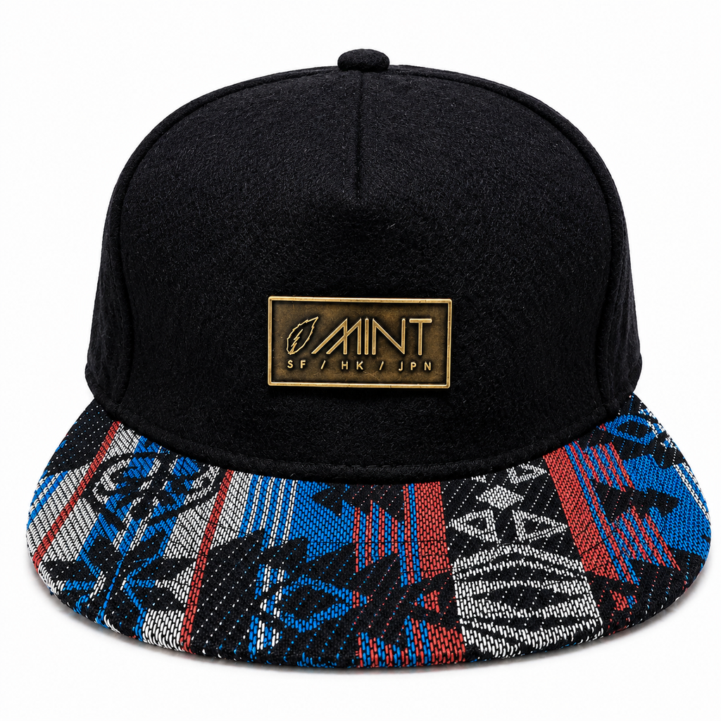 Black cap with a colorful patterned brim and gold logo on a white background